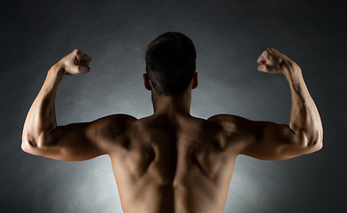 Image showing young man showing biceps