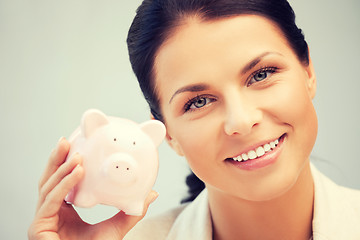 Image showing lovely woman with piggy bank