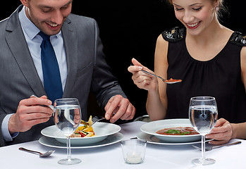 Image showing close up of couple eating at restaurant