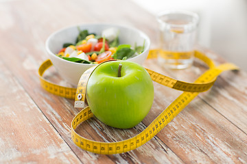 Image showing close up of green apple and measuring tape