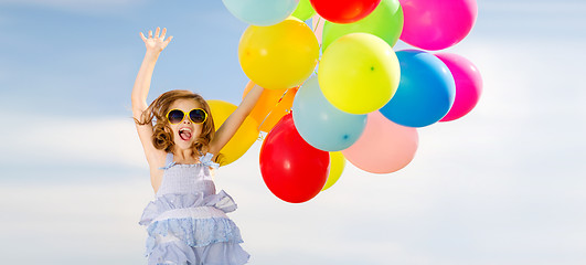 Image showing happy jumping girl with colorful balloons