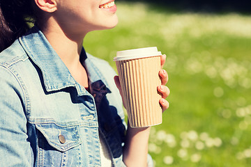 Image showing close up of smiling girl with coffee cup outdoors