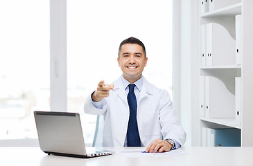 Image showing smiling doctor pointing finger at you in office