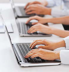 Image showing group of people working with laptops in office