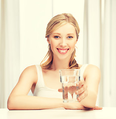 Image showing young smiling woman with glass of water