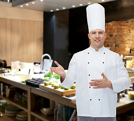 Image showing happy male chef cook inviting