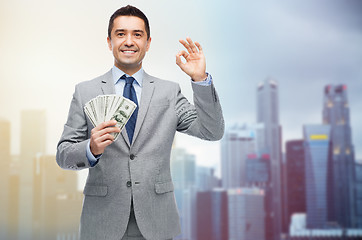 Image showing smiling businessman with american dollar money