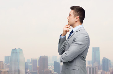 Image showing thinking businessman in suit making decision