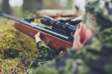 Image showing soldier or hunter shooting with gun in forest