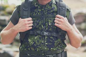 Image showing close up of young soldier with backpack in forest