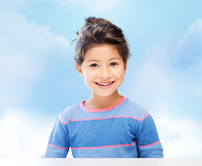 Image showing little girl over blue sky background