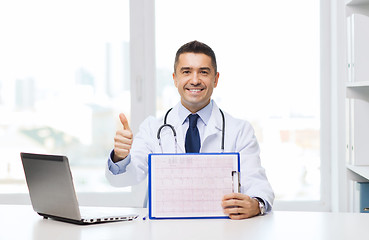 Image showing happy doctor with clipboard showing thumbs up