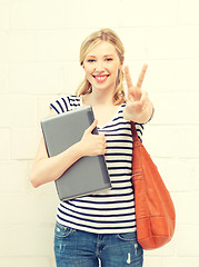 Image showing smiling teenage girl with laptop