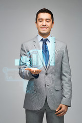 Image showing happy businessman showing virtual chart projection