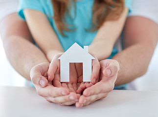 Image showing close up of man and girl hands with paper house