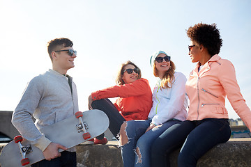 Image showing happy teenage friends with longboard on street