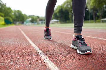 Image showing close up of woman feet running on track from back