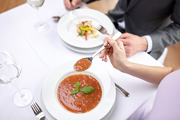 Image showing close up of couple eating appetizers at restaurant