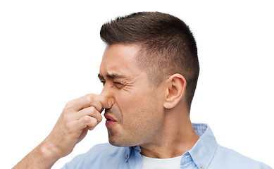 Image showing man wrying of unpleasant smell