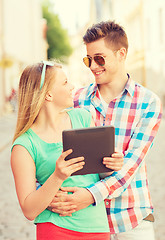 Image showing smiling couple with tablet pc in city