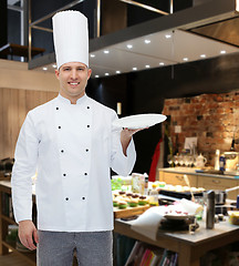 Image showing happy male chef cook showing empty plate