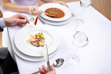 Image showing close up of couple eating appetizers at restaurant