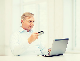 Image showing old man with laptop and credit card at home