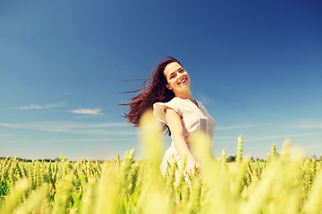 Image showing smiling young woman on cereal field