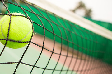 Image showing Tennis ball in net