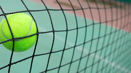 Image showing Tennis ball in net