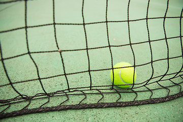 Image showing Tennis ball in net