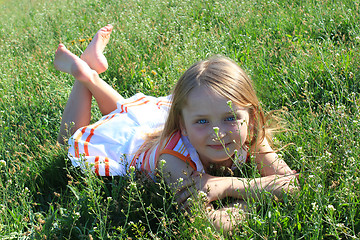 Image showing little girl lying on the grass