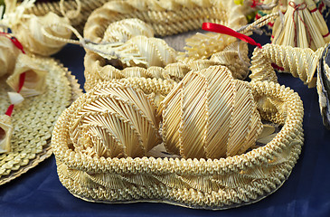 Image showing Original Souvenirs of woven straw are sold at the fair.
