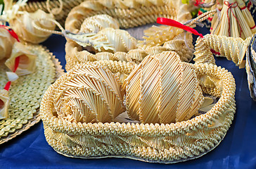 Image showing Original Souvenirs of woven straw are sold at the fair.