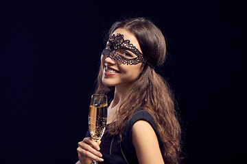 Image showing Happe woman in mask holding glass with champagne