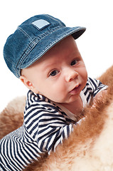 Image showing Portrait of adorable child in hat lying on fur