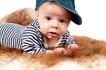 Image showing Portrait of adorable child in hat lying on fur