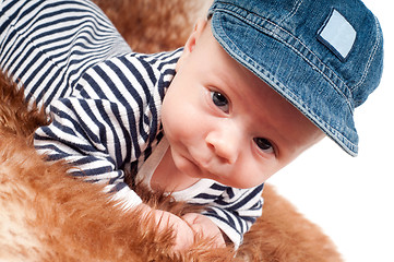 Image showing Portrait of adorable baby in cap lying on fur