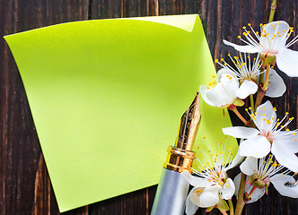 Image showing flowers and paper on wooden background