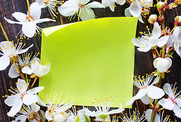 Image showing flowers and paper on wooden background