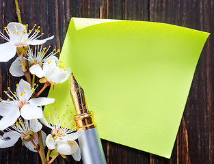 Image showing flowers and paper on wooden background