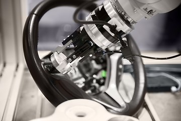Image showing Robotic arm tearing down steering wheel