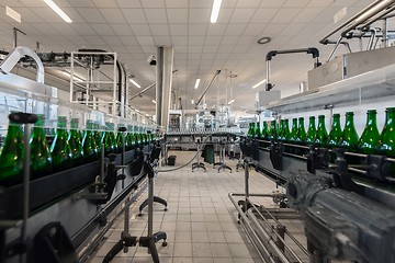 Image showing Many bottles on conveyor belt