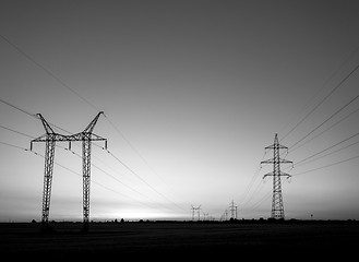 Image showing Large transmission towers at sunset