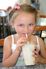 Image showing little girl drinking the cocktail in fastfood