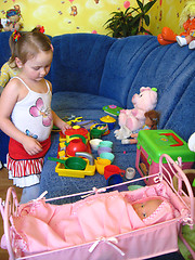 Image showing girl playing with toys in her room