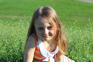 Image showing portrait of little girl lying on the grass