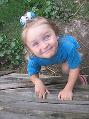 Image showing little girl with blue eyes staring up