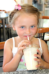 Image showing beautiful girl drinking the cocktail in fastfood