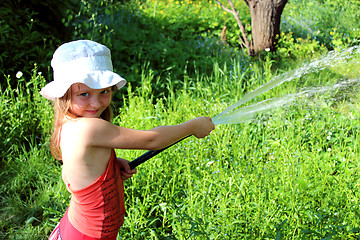 Image showing girl watering a kitchen garden